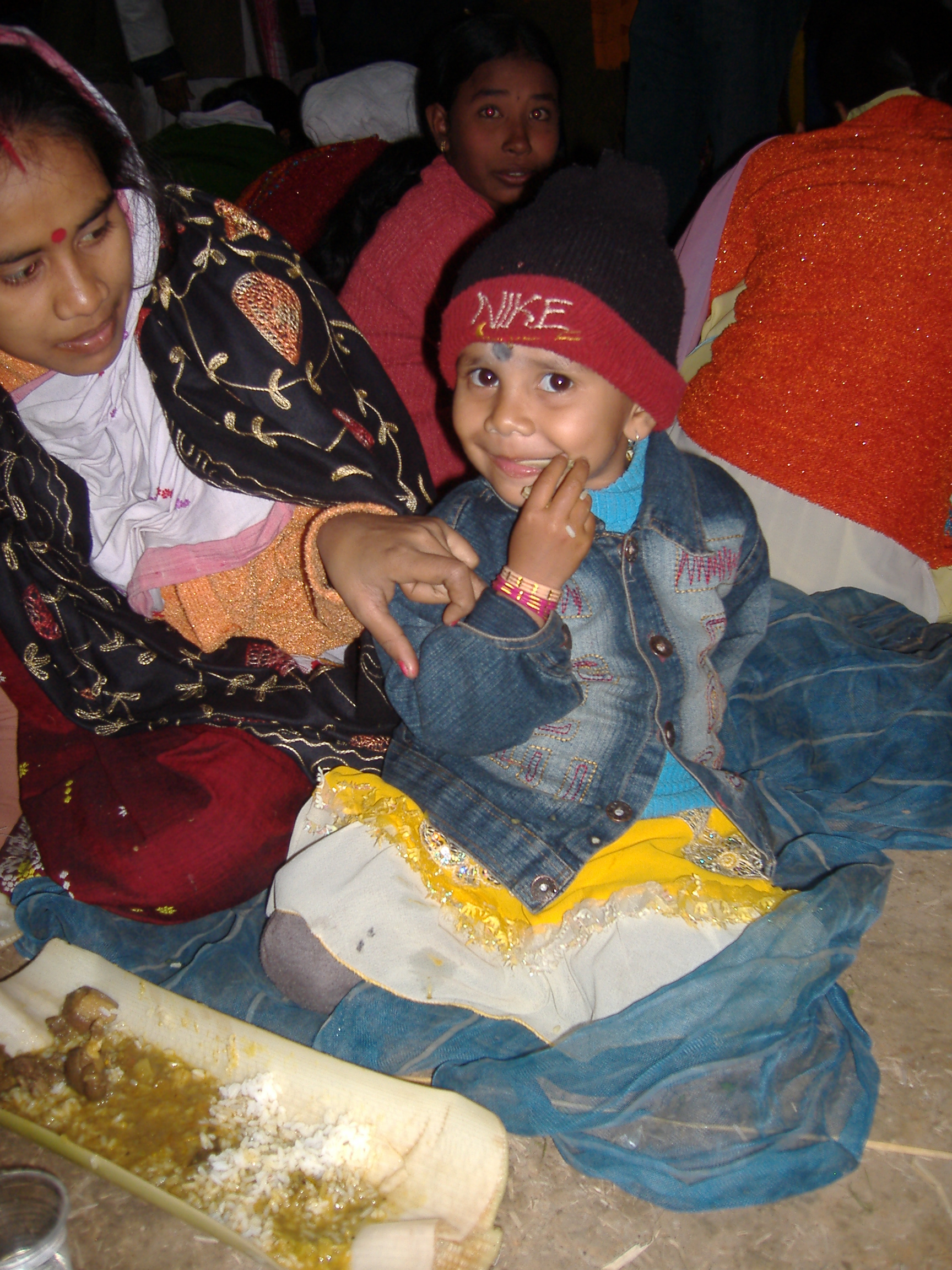 Indian kid eating from bamboo dish